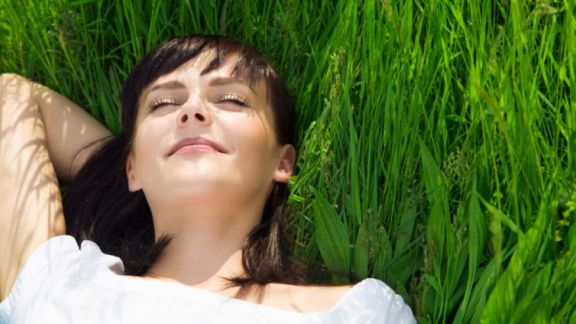 happy woman in grass formatted istock