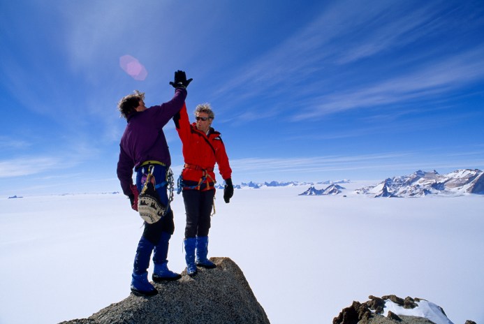top-of-mountain-high-five-accomplishment-goal